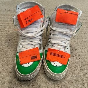 Green, white, and orange distressed Off White sneakers